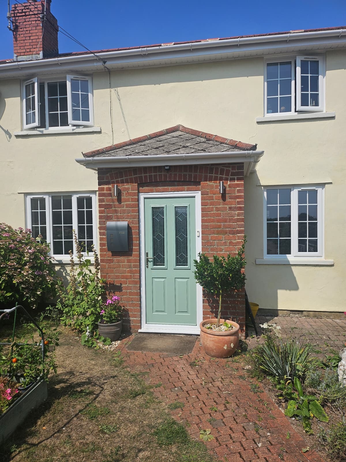 White Double Glazed Windows with Georgian Bar Glass and a Composite Front Door in Chartwell Green