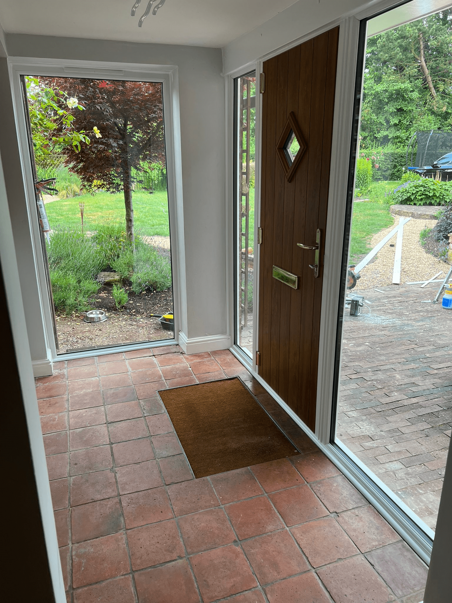 Golden Oak Composite Door with 2 fully glazed side panels and a fixed window